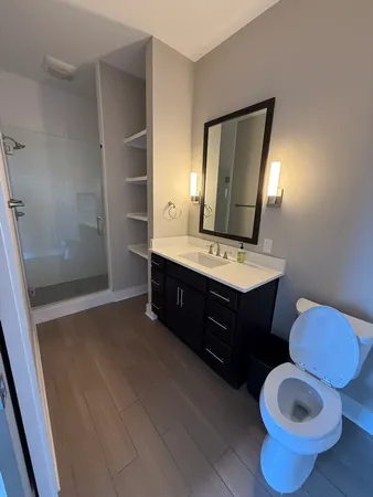 a bathroom with a sink toilet and mirror