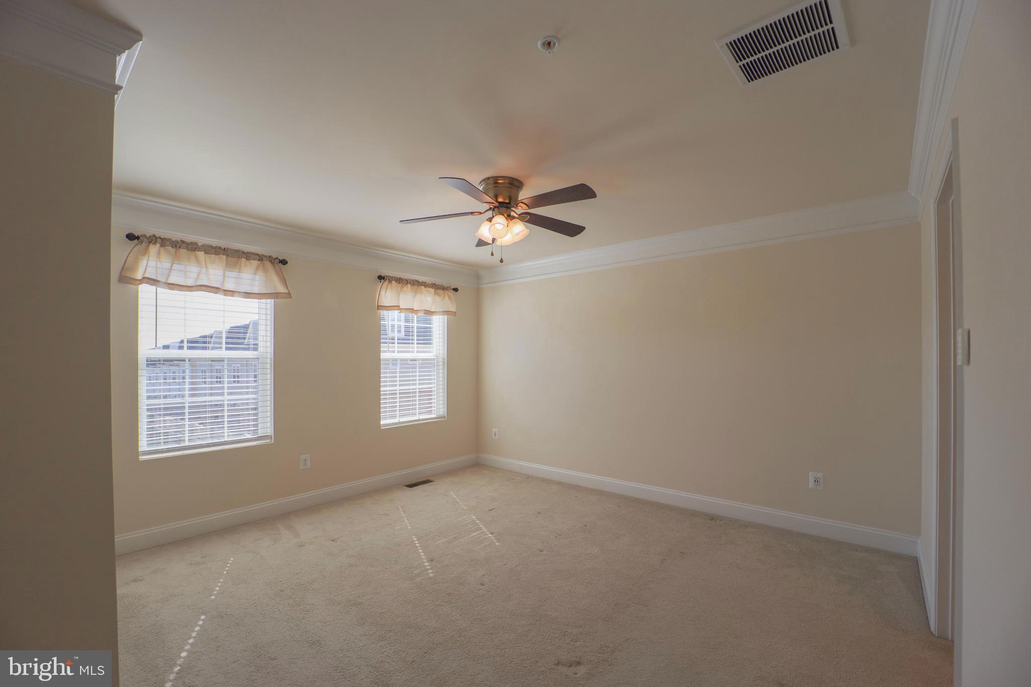 5054 Judicial Way Frederick, MD 21703 - Photo 15 of 28 an empty room with windows and ceiling fan