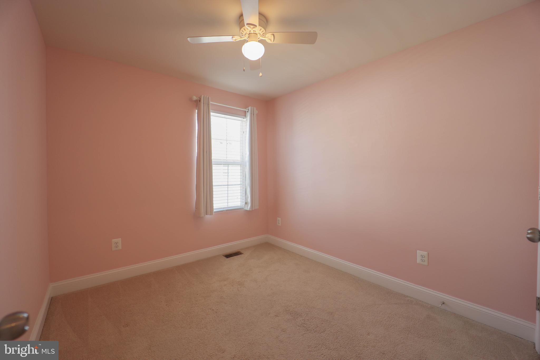 5054 Judicial Way Frederick, MD 21703 - Photo 23 of 28 an empty room with a chandelier fan and windows