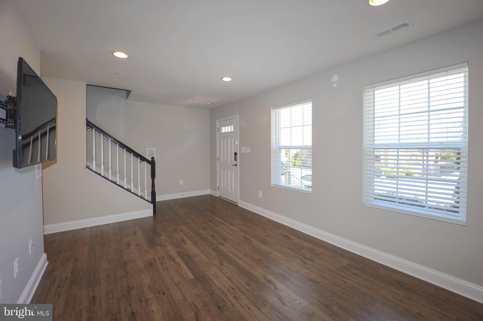 5054 Judicial Way Frederick, MD 21703 - Photo 4 of 28 a view of an empty room with wooden floor and a window