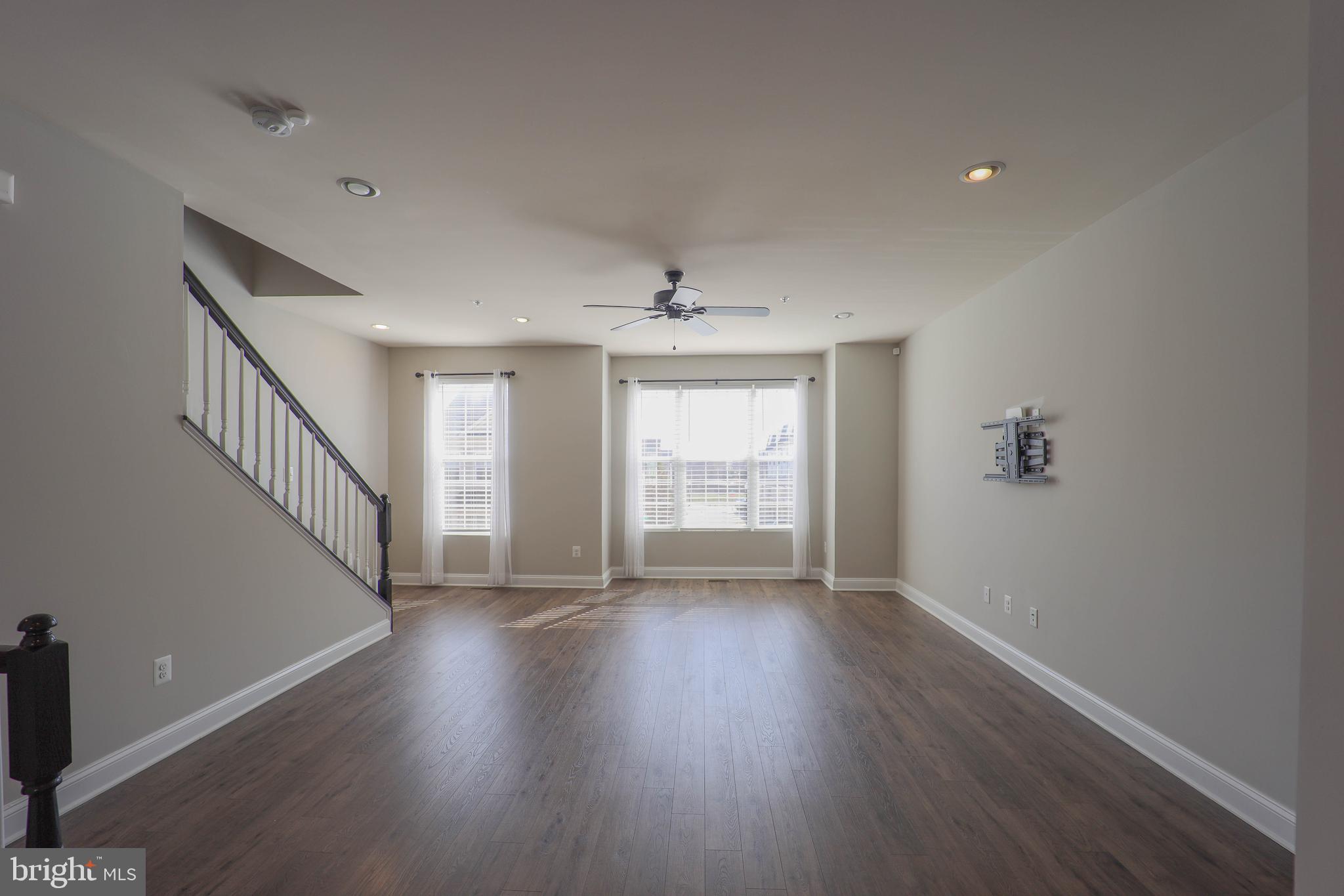 5054 Judicial Way Frederick, MD 21703 - Photo 5 of 28 a view of an empty room with wooden floor and a window