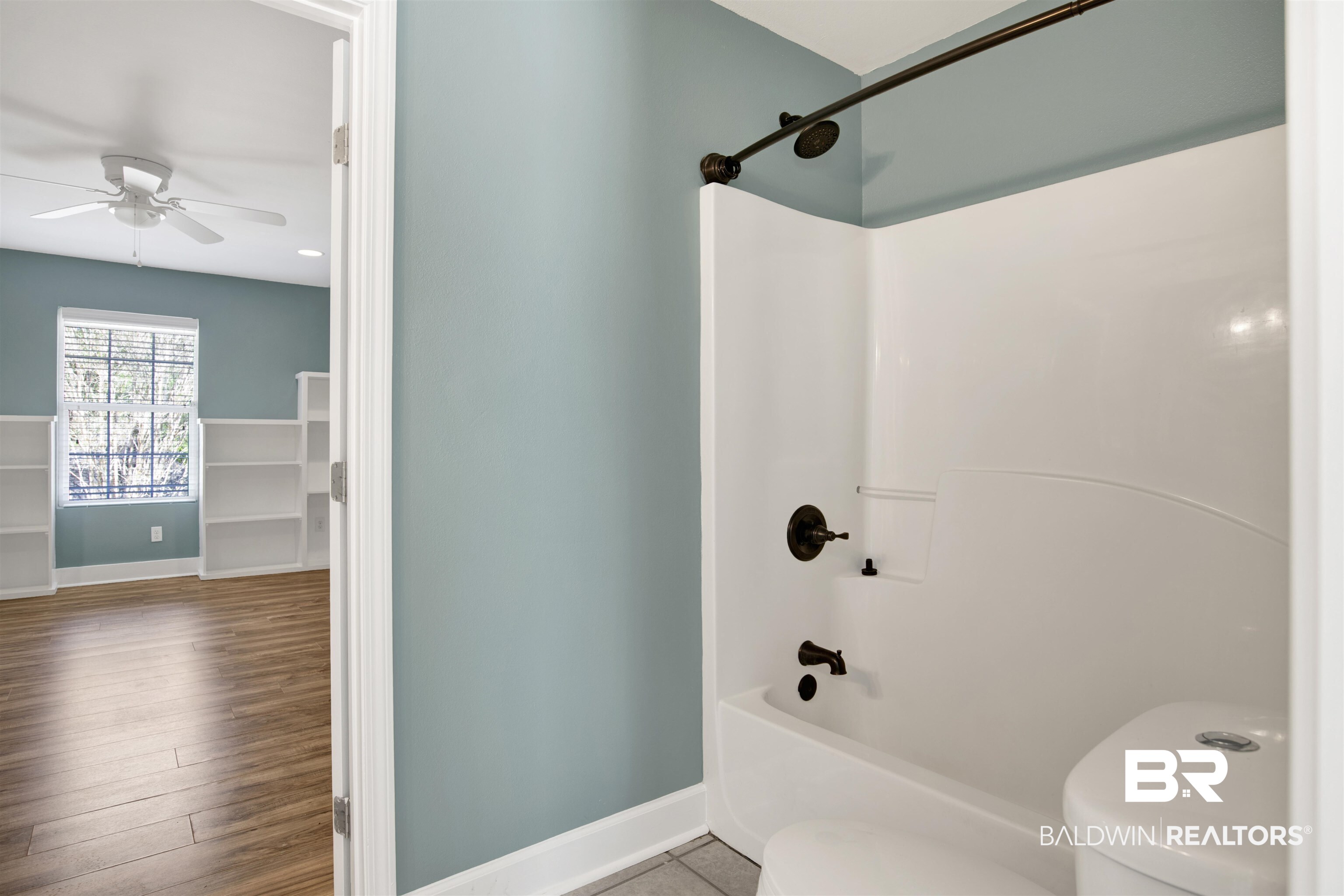 11835 Island Drive Foley, AL 36535 - Photo 20 of 53 Bathroom with shower combination, wood finished floors, and a ceiling fan