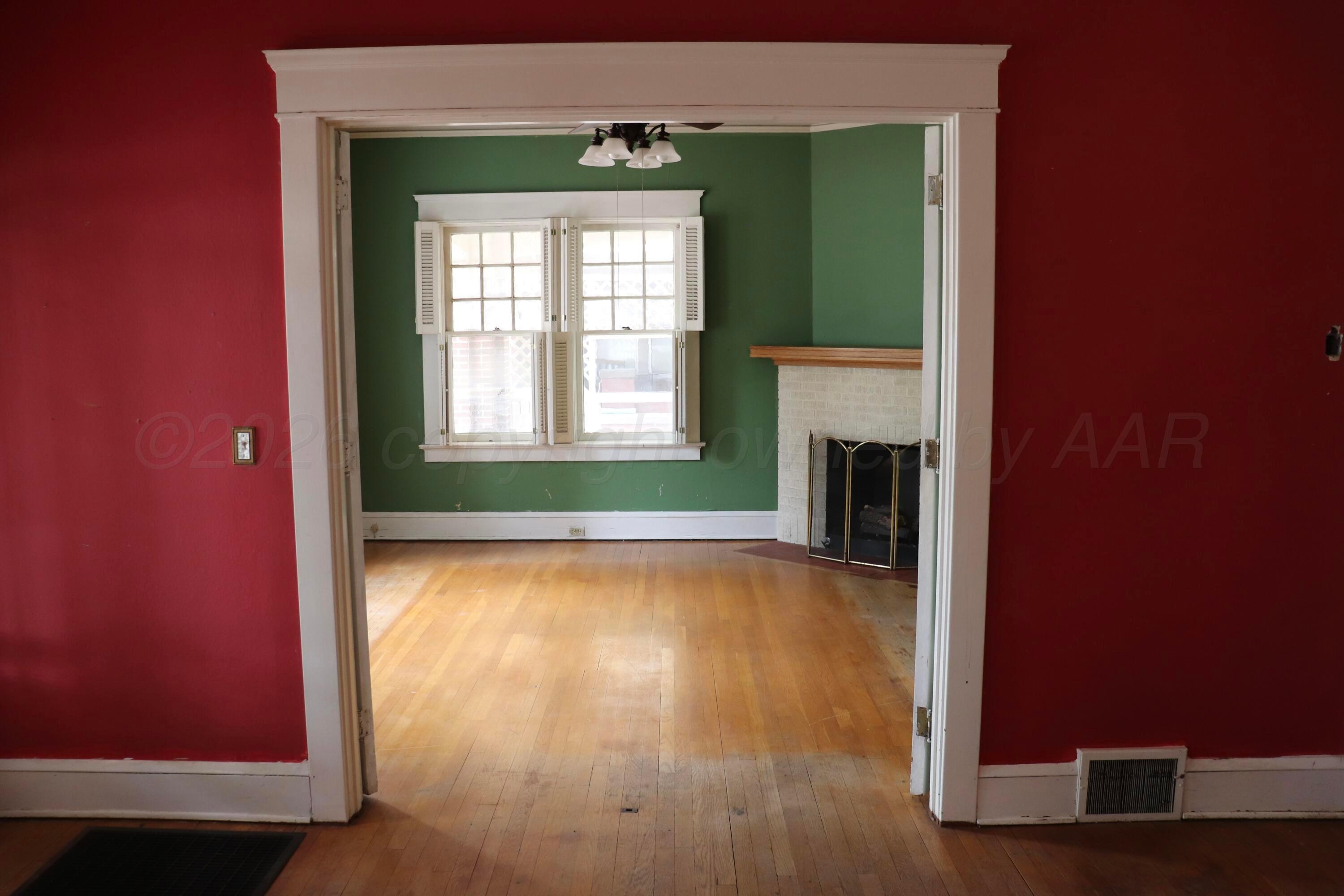 1912 South Tyler Street Amarillo, TX 79109 - Photo 13 of 74 a view of a livingroom with wooden floor and a fireplace