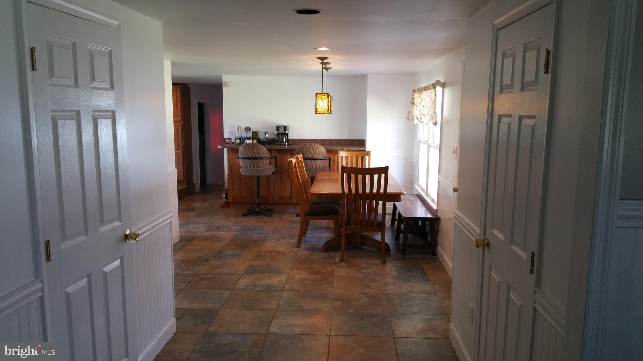 Looking thru foyer to dining area with tile floor