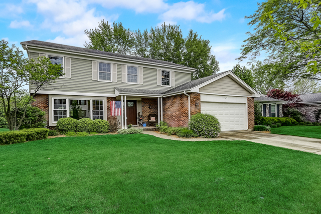2767 Sun Valley Road Lisle, IL 60532 - Photo 1 of 23 a view of a yard in front of a house with plants and large tree