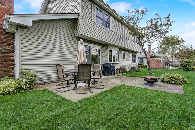 2767 Sun Valley Road Lisle, IL 60532 - Photo 20 of 23 a view of a chair and table in backyard of the house