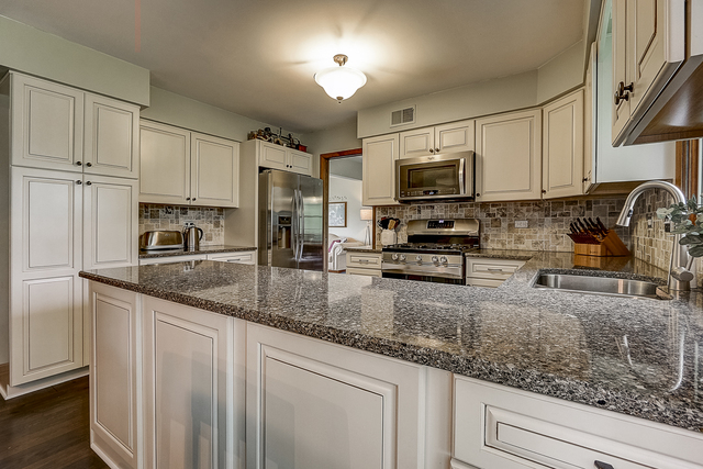 2767 Sun Valley Road Lisle, IL 60532 - Photo 4 of 23 a kitchen with stainless steel appliances granite countertop a sink a stove and cabinets