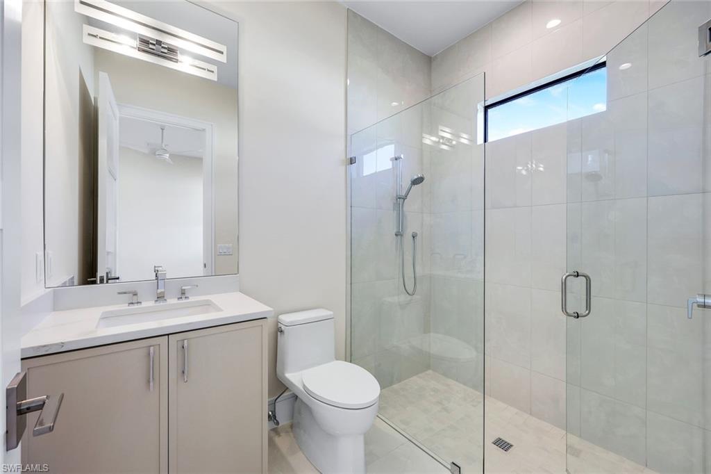 14282 Charthouse Circle Naples, FL 34114 - Photo 23 of 48 Bathroom featuring a shower stall and vanity