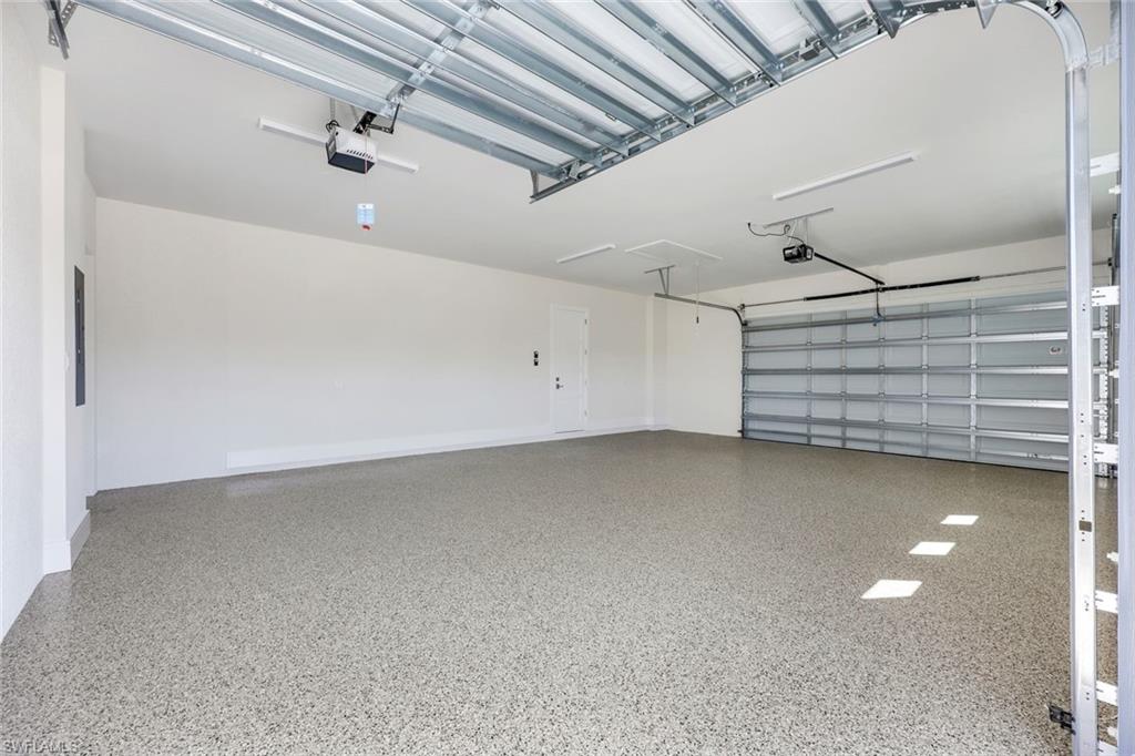 14282 Charthouse Circle Naples, FL 34114 - Photo 39 of 48 Garage featuring a garage door opener and electric panel