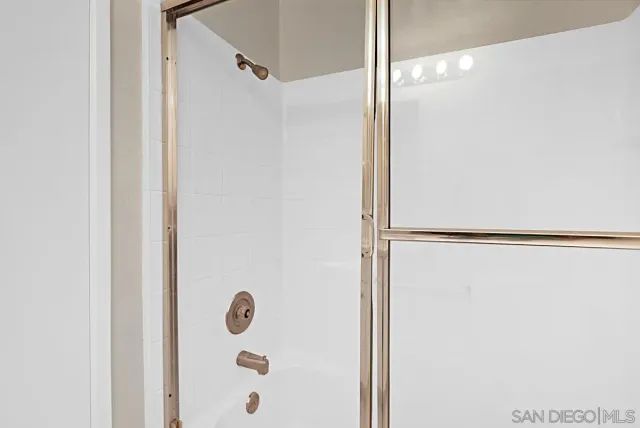 a bathroom with a glass shower door
