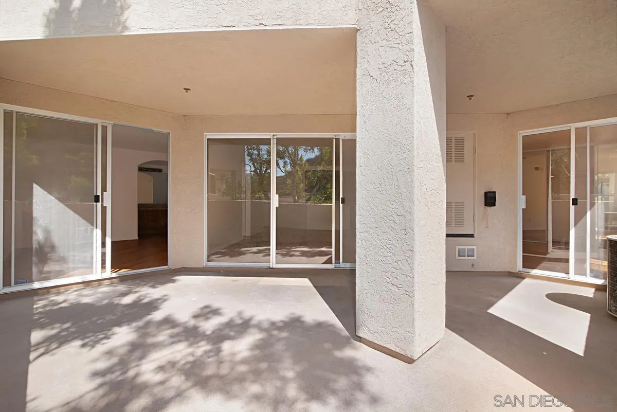 11235 Affinity Court, Unit 68 San Diego, CA 92131 - Photo 24 of 29 a view of a hallway with wooden floor and a living room