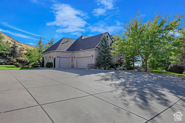 165 East 1550th South Perry, UT 84302 - Photo 12 of 26 View of side of property featuring a garage and a mountain view