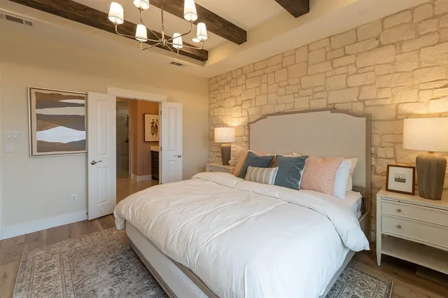 a bed room with a bed and a chandelier