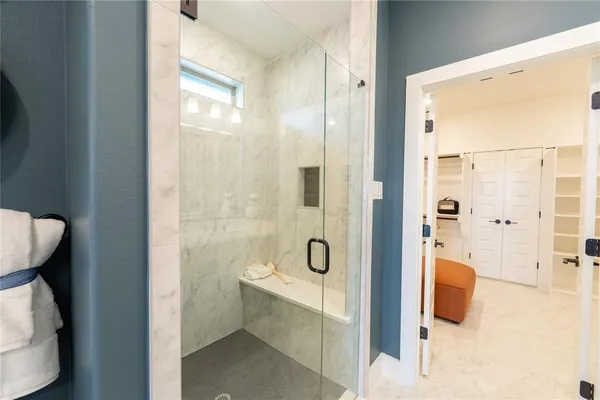 a bathroom with a double vanity sink mirror and shower