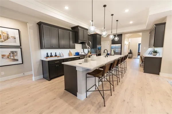 a large kitchen with a table and chairs