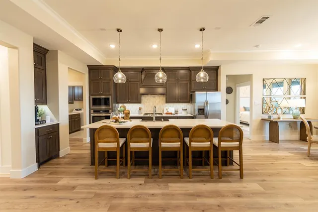 a large kitchen with lots of counter space and chandelier