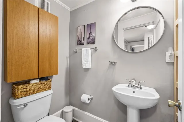 a bathroom with a sink a mirror and a toilet
