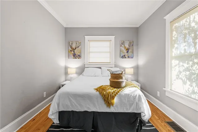 a bedroom with a bed and wooden floor