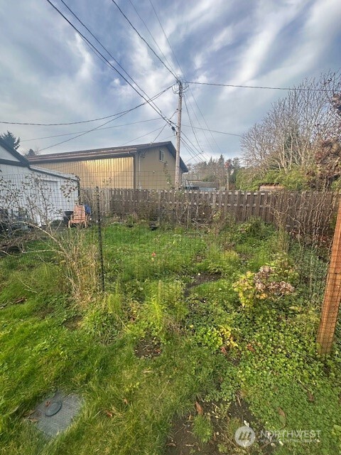1302 West 5th Street Aberdeen, WA 98520 - Photo 24 of 26 a backyard of a house with lots of green space and outdoor seating