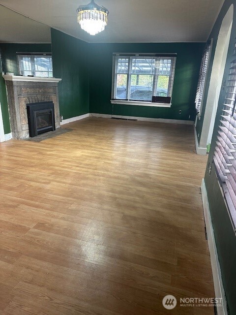 1302 West 5th Street Aberdeen, WA 98520 - Photo 4 of 26 a view of empty room with window and fireplace