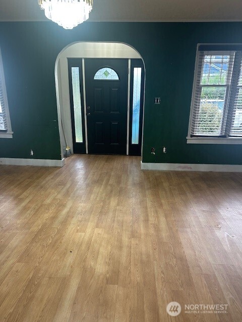 1302 West 5th Street Aberdeen, WA 98520 - Photo 5 of 26 a view of a livingroom with wooden floor and a window