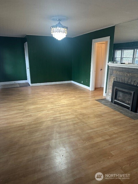 1302 West 5th Street Aberdeen, WA 98520 - Photo 6 of 26 a view of empty room with window and fireplace
