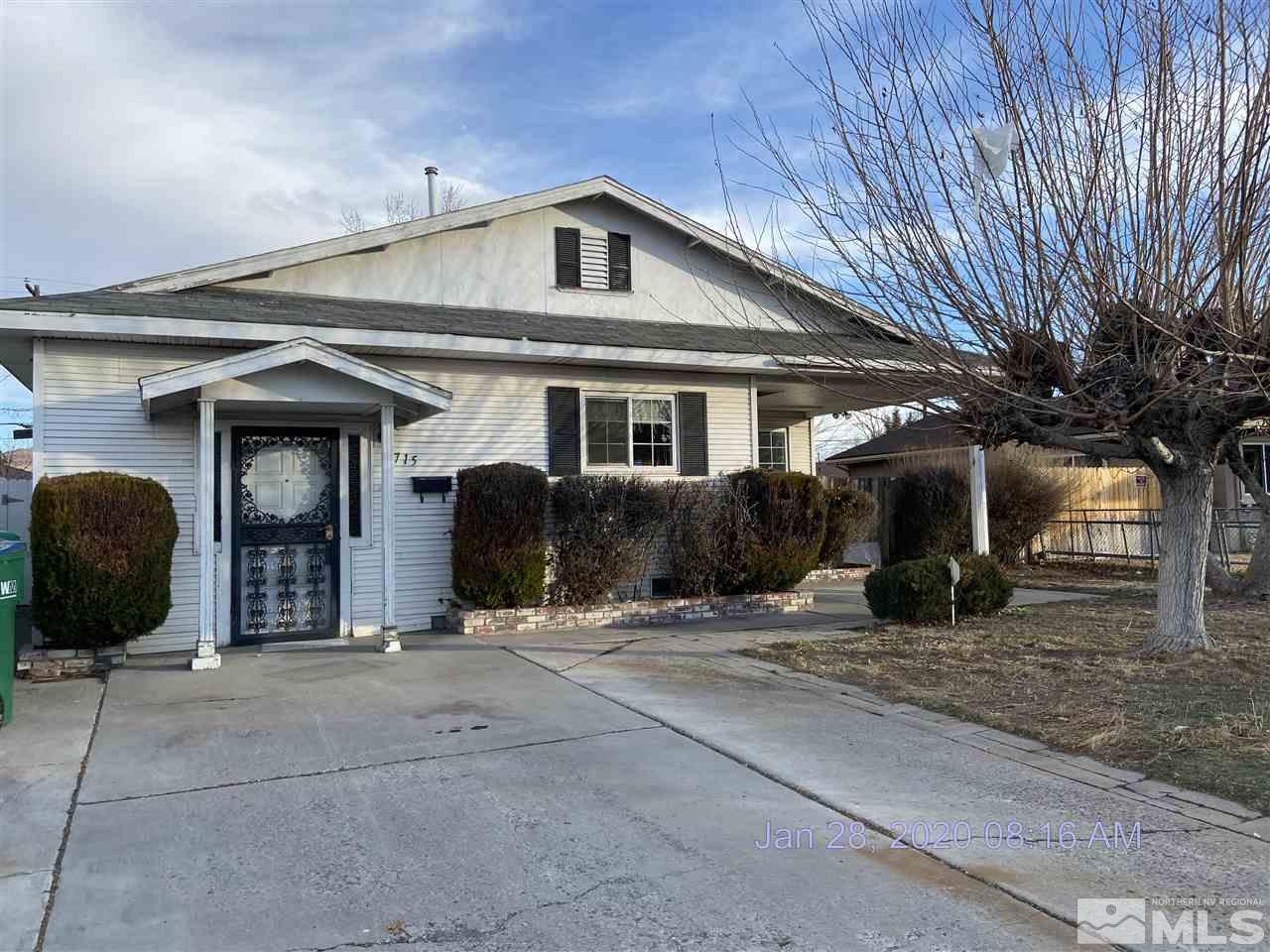 1715 Haddock Drive Reno, NV 89512 - Photo 1 of 17 a front view of a house with glass windows and a garage