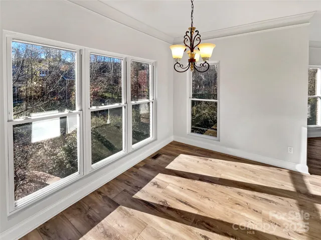 a view of a living room with a large window and chandelier