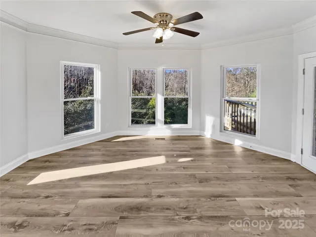 a view of an empty room with a window and balcony view