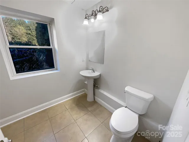 a white toilet sitting next to a bathroom sink