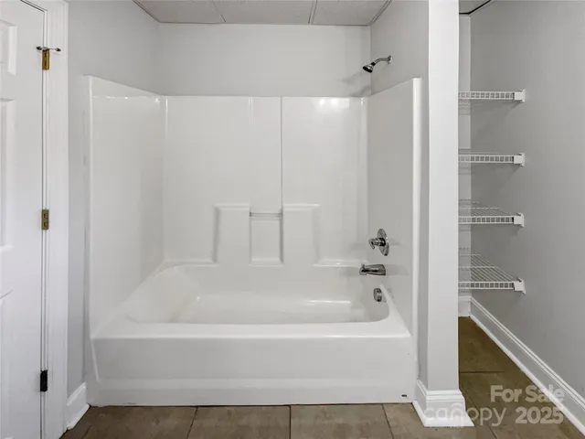 a bathroom with a bathtub and a shower