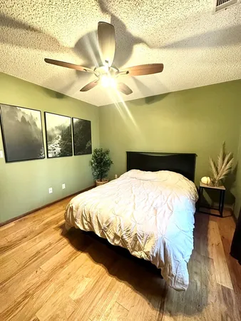 a large bed sitting in a bedroom next to a window