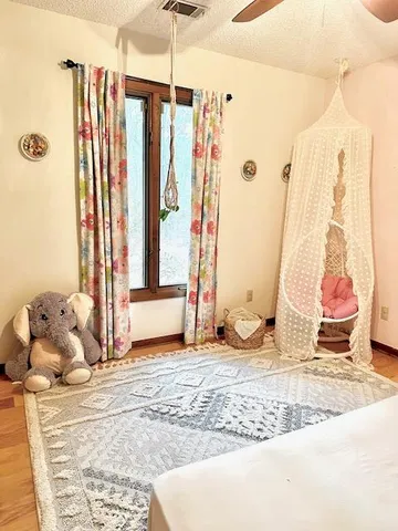 a view of a livingroom with wooden floor and a window
