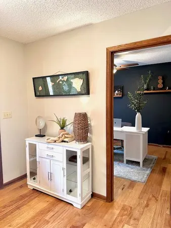 a living room with a wooden floor and furniture