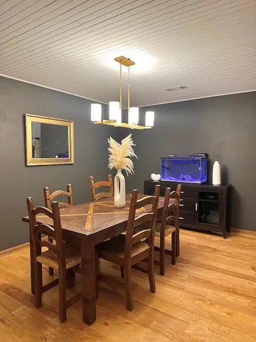a dining room with furniture and wooden floor