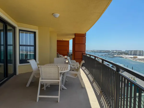 a view of a balcony dining table and chairs