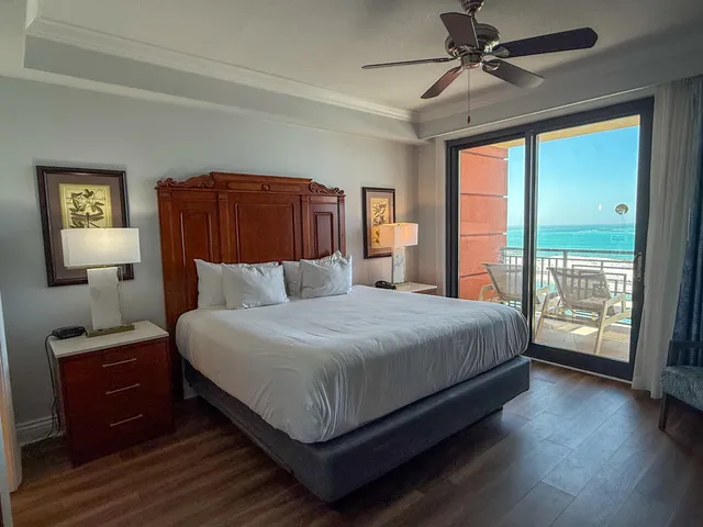 a bedroom with a large bed and a window