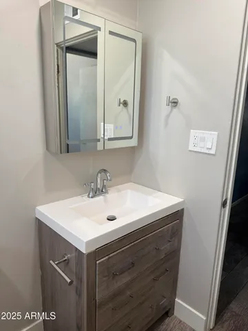 a bathroom with a sink and a mirror