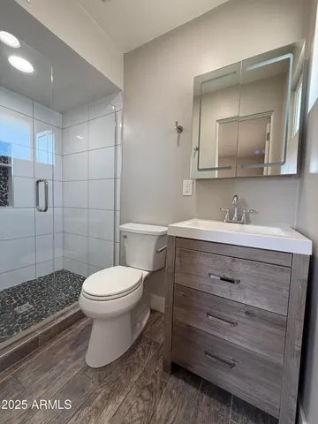 a bathroom with a sink toilet and shower