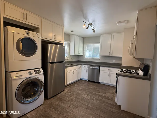a kitchen with a stove top oven sink and cabinets