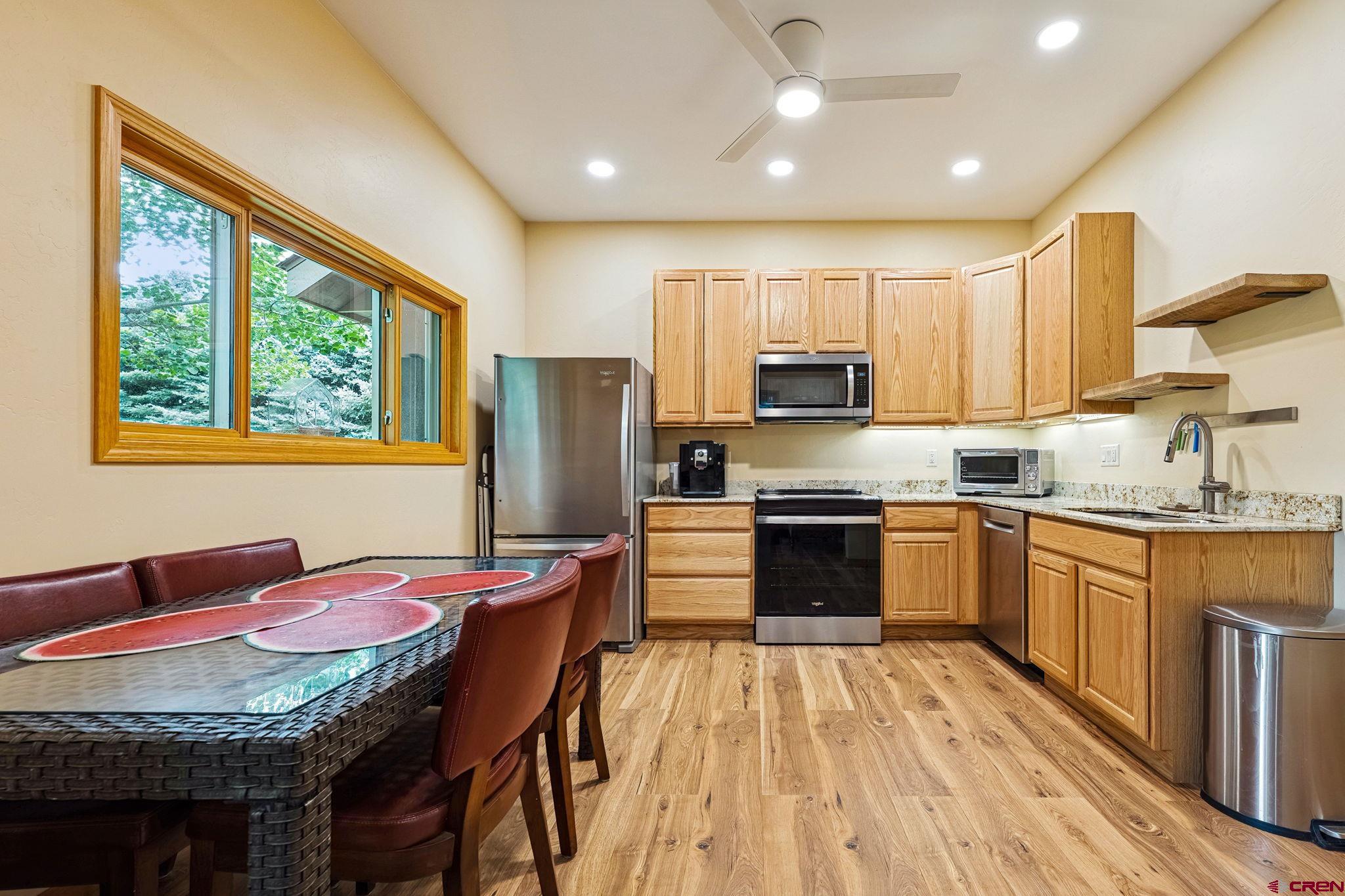 67 Gleneagles Drive Durango, CO 81301 - Photo 23 of 43 a kitchen with stainless steel appliances granite countertop a stove refrigerator sink and cabinets