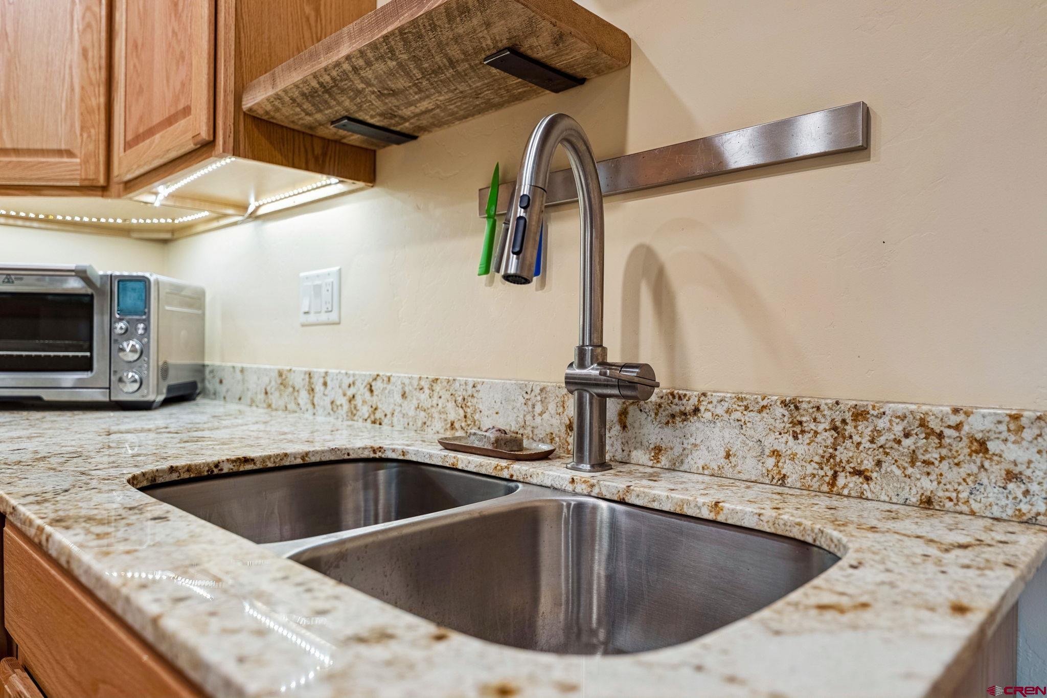 67 Gleneagles Drive Durango, CO 81301 - Photo 26 of 43 a kitchen with a sink and a mirror