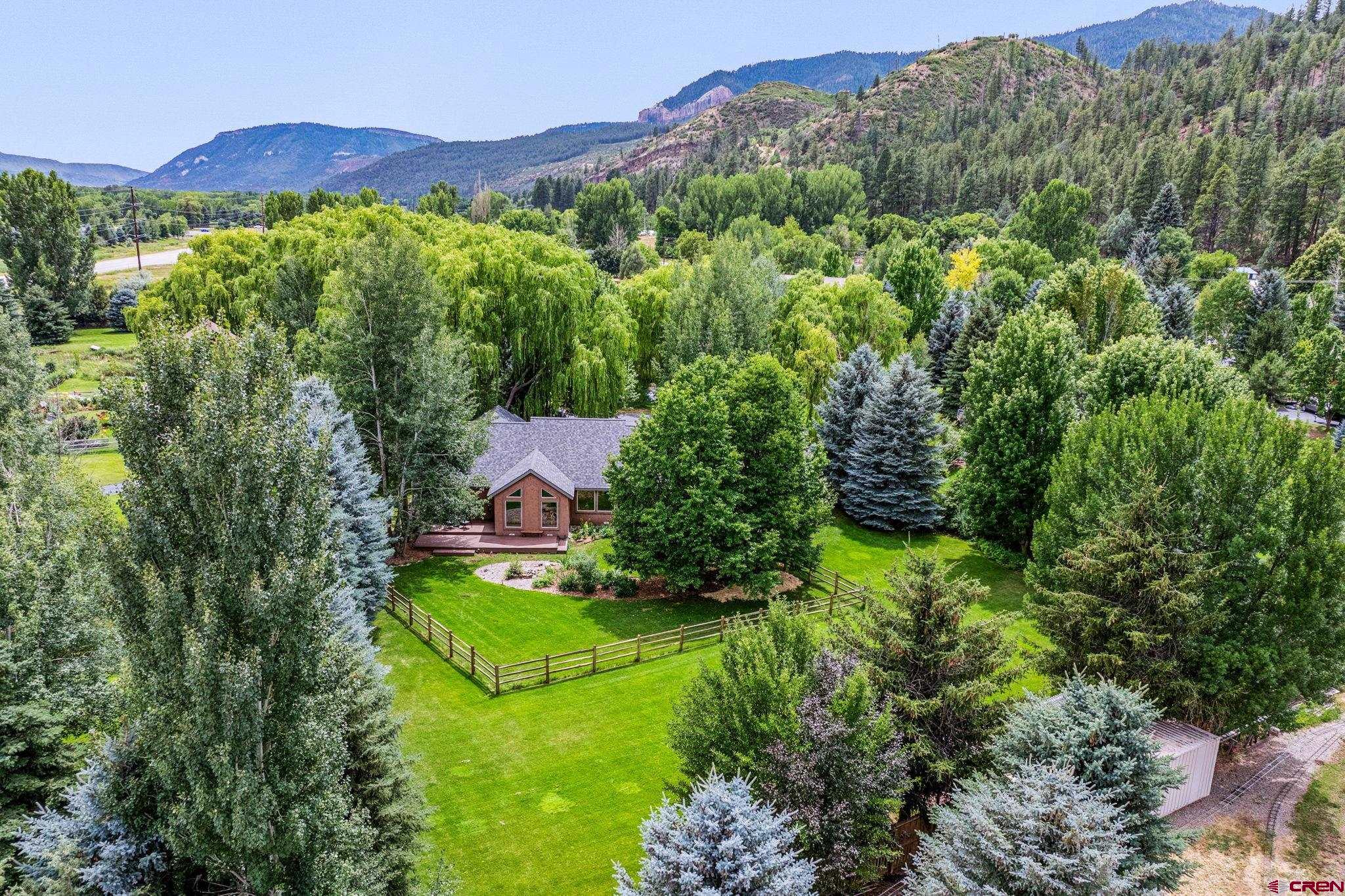 67 Gleneagles Drive Durango, CO 81301 - Photo 39 of 43 an aerial view of green landscape with trees houses and mountain view
