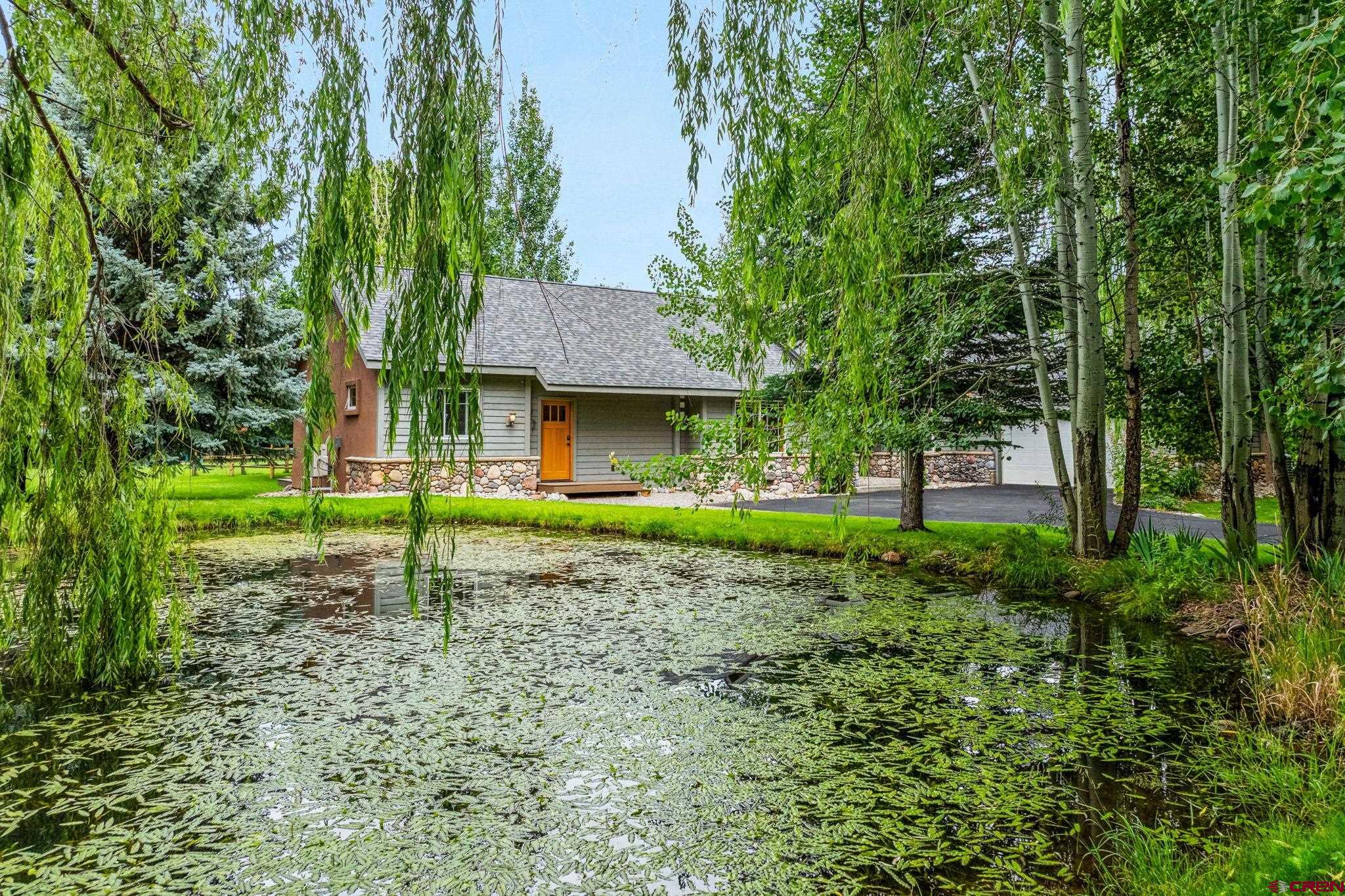 67 Gleneagles Drive Durango, CO 81301 - Photo 41 of 43 a house with green field in front of it