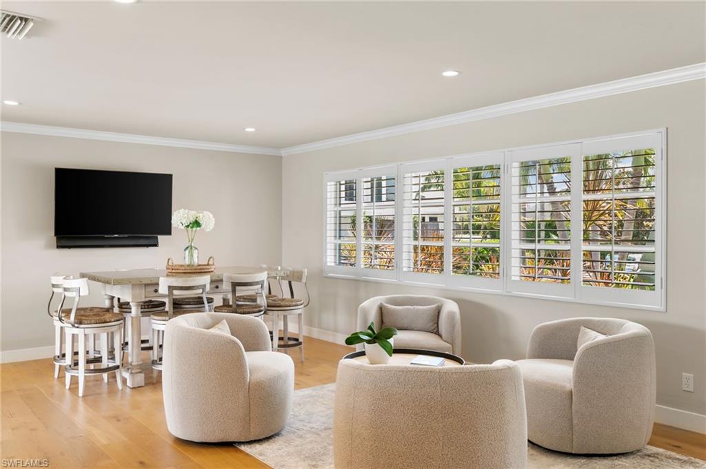 2140 Shad Court Naples, FL 34102 - Photo 25 of 44 a living room with furniture and a flat screen tv