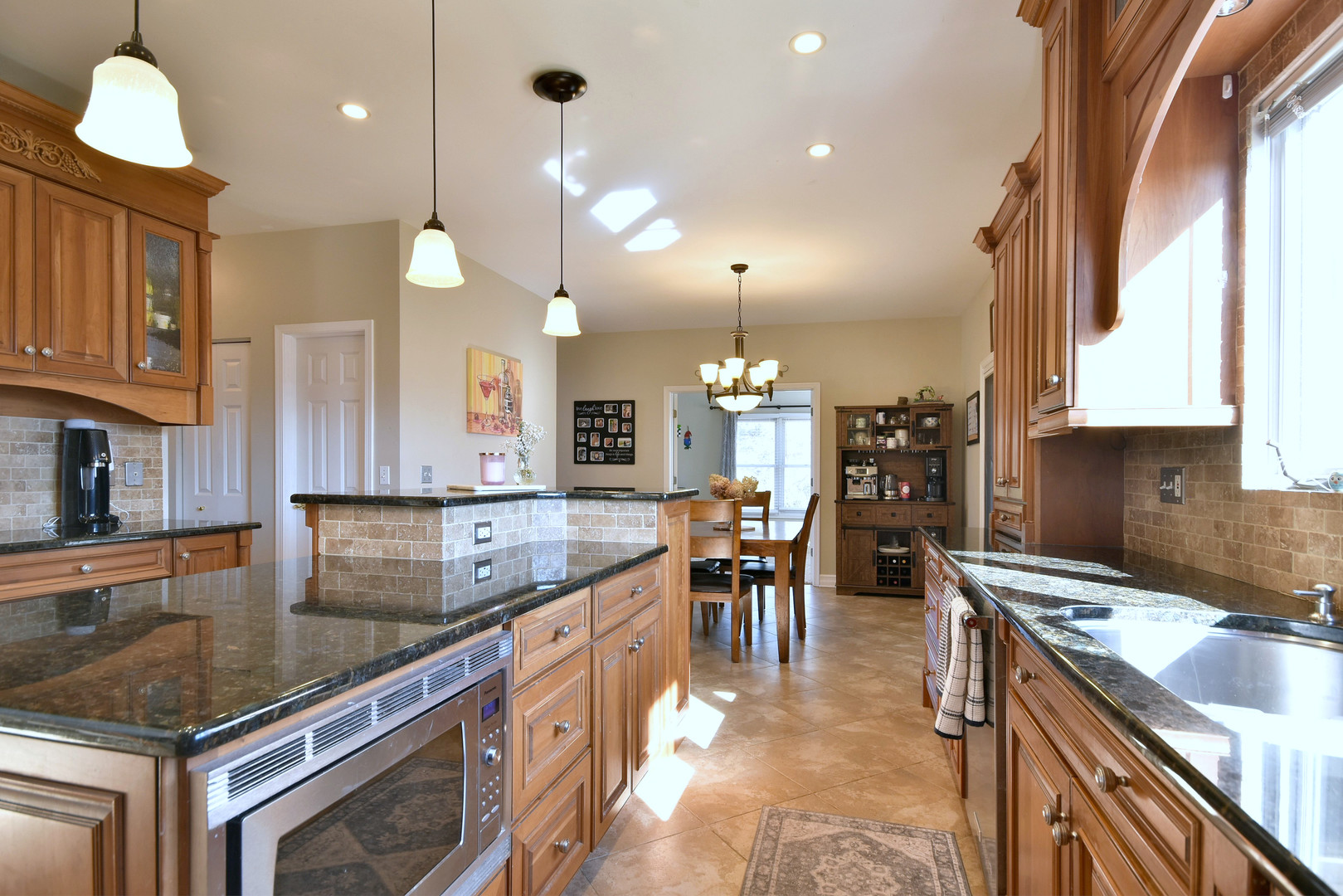 781 Hayrack Drive Algonquin, IL 60102 - Photo 11 of 54 a kitchen with kitchen island granite countertop a sink a stove and a wooden cabinets