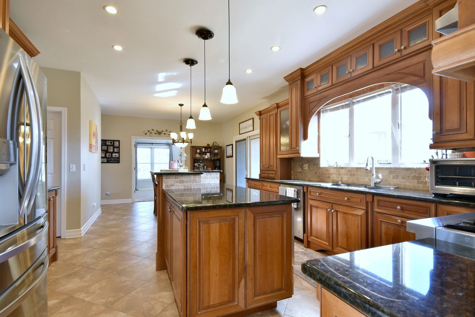 781 Hayrack Drive Algonquin, IL 60102 - Photo 12 of 54 a kitchen with stainless steel appliances granite countertop a sink a stove and a refrigerator