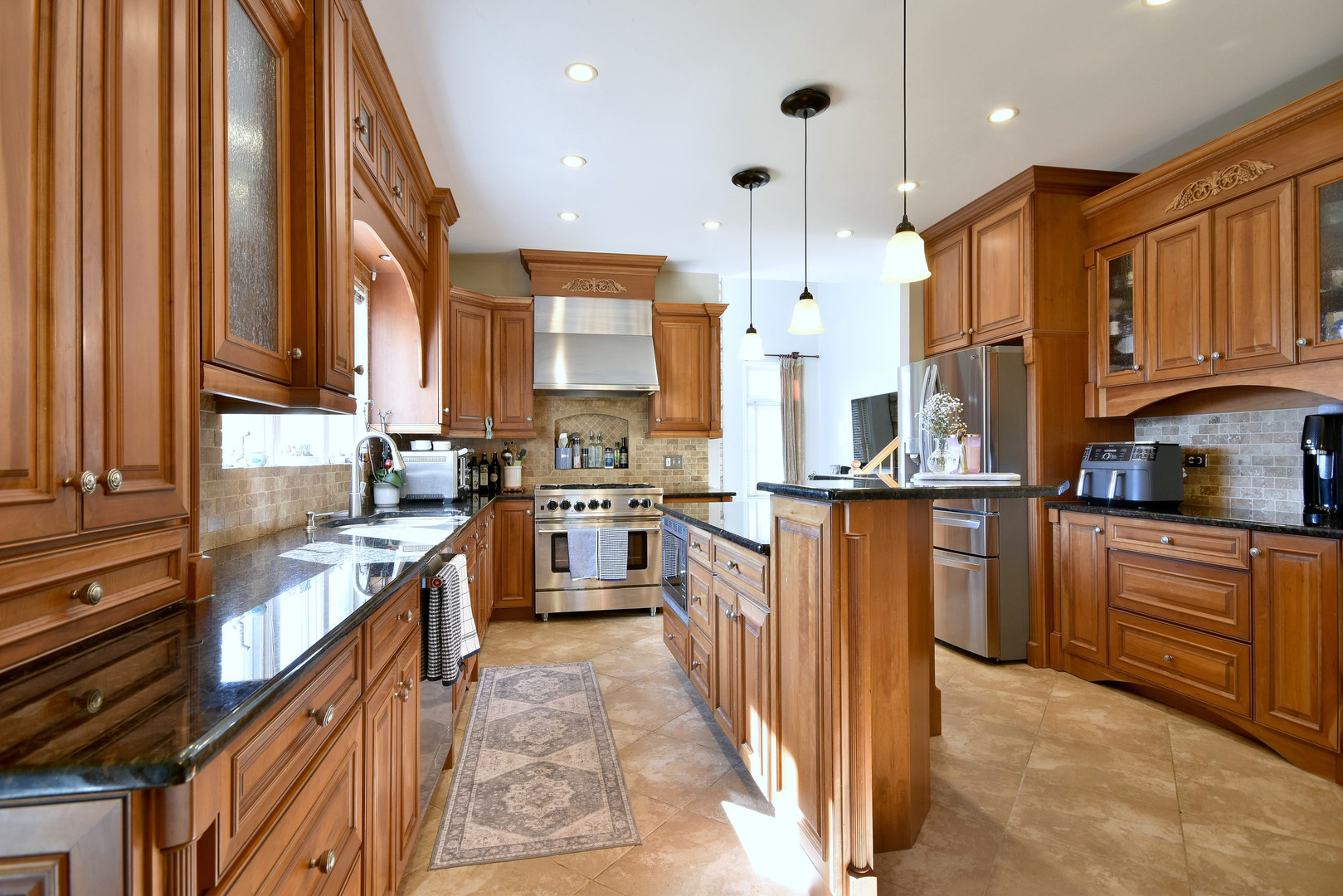 781 Hayrack Drive Algonquin, IL 60102 - Photo 10 of 54 a kitchen with stainless steel appliances granite countertop wooden cabinets a sink and a stove
