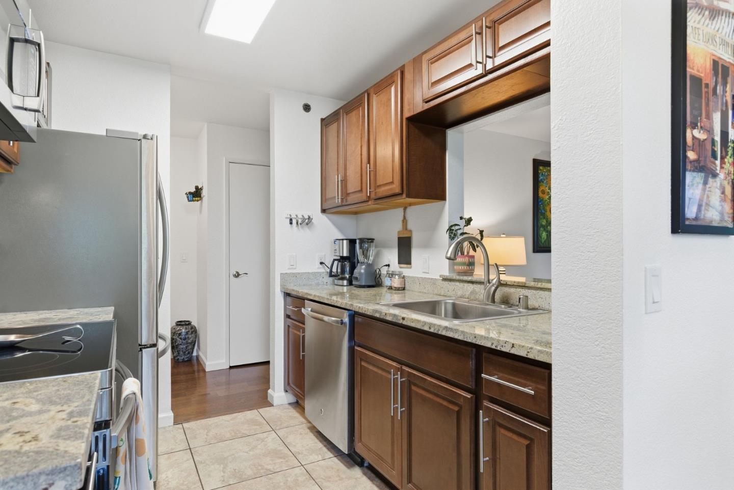 673 Royston Lane, Unit 233 Hayward, CA 94544 - Photo 5 of 32 a kitchen with stainless steel appliances granite countertop a sink stove and cabinets