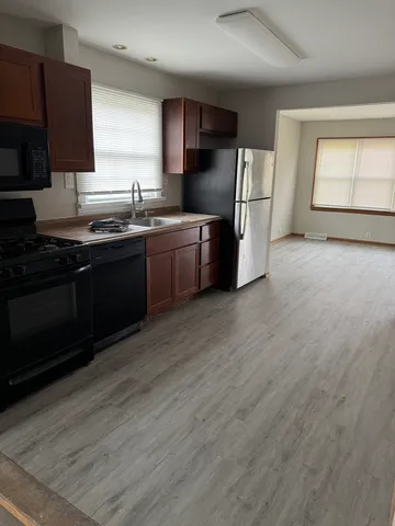 a kitchen with a sink stove and refrigerator